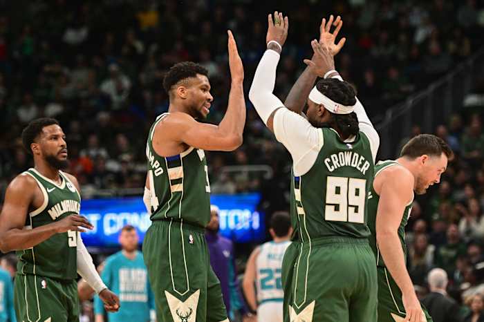 Milwaukee Bucks forward Giannis Antetokounmpo (34) celebrates with forward Jae Crowder (99) i